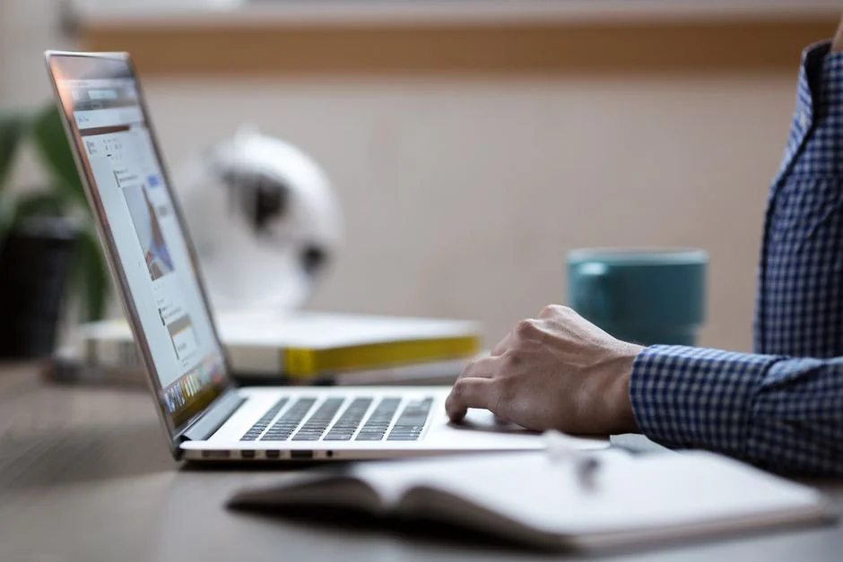A team reviews financial graphs and digital information on tablets in an office environment.